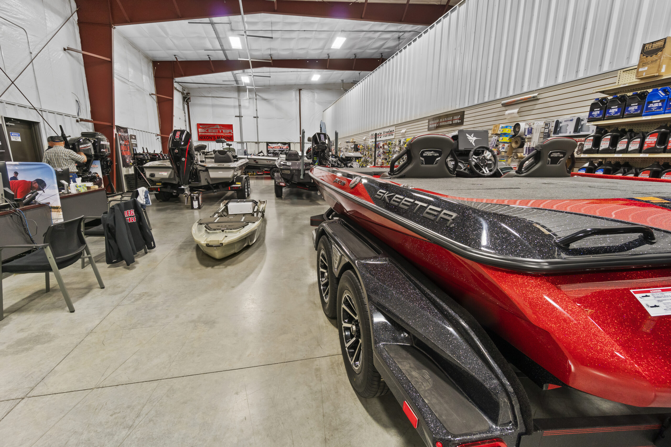 Boat showroom with various models displayed.