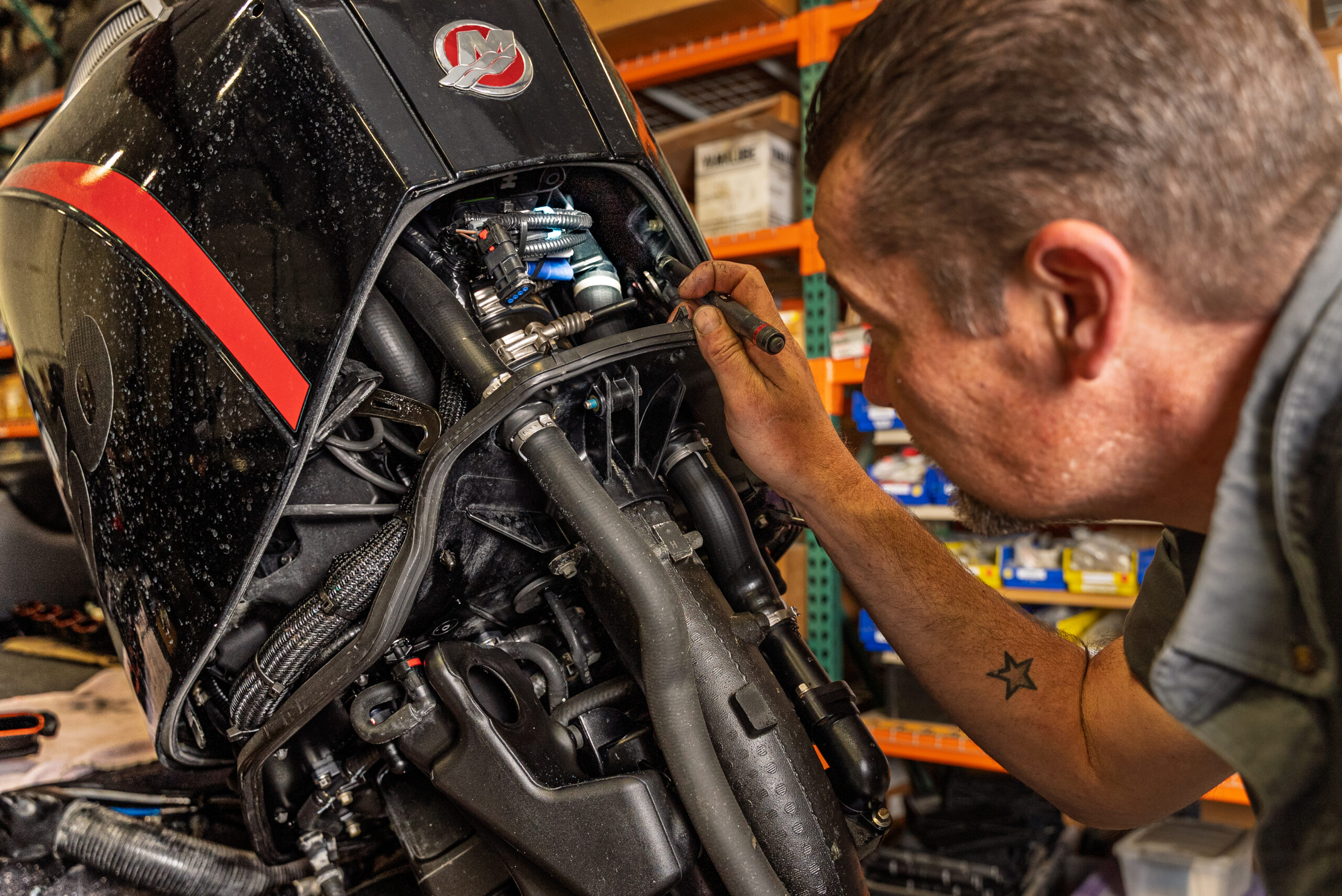 Mechanic inspecting a boat engine.