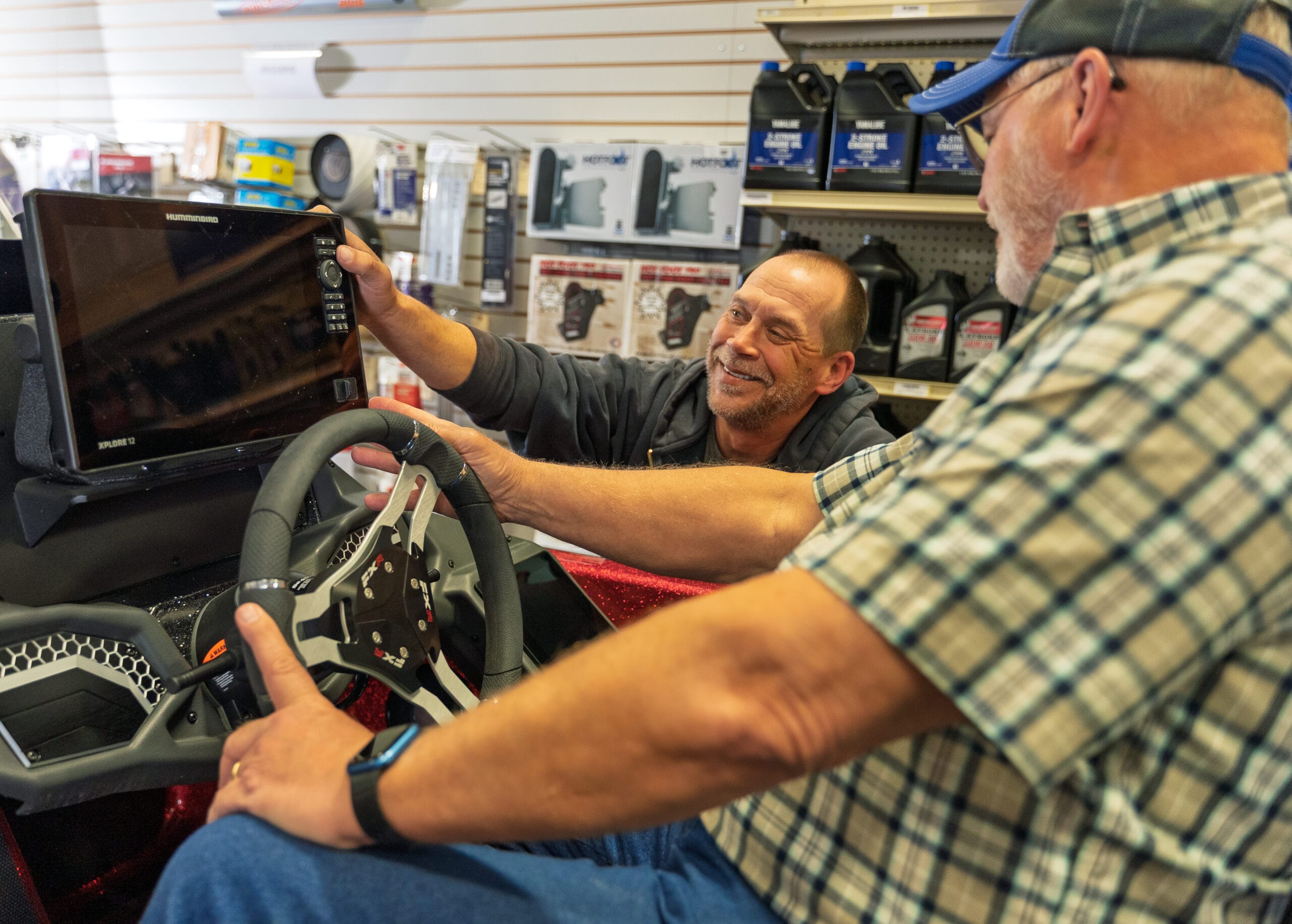 Two men discuss marine electronics installation