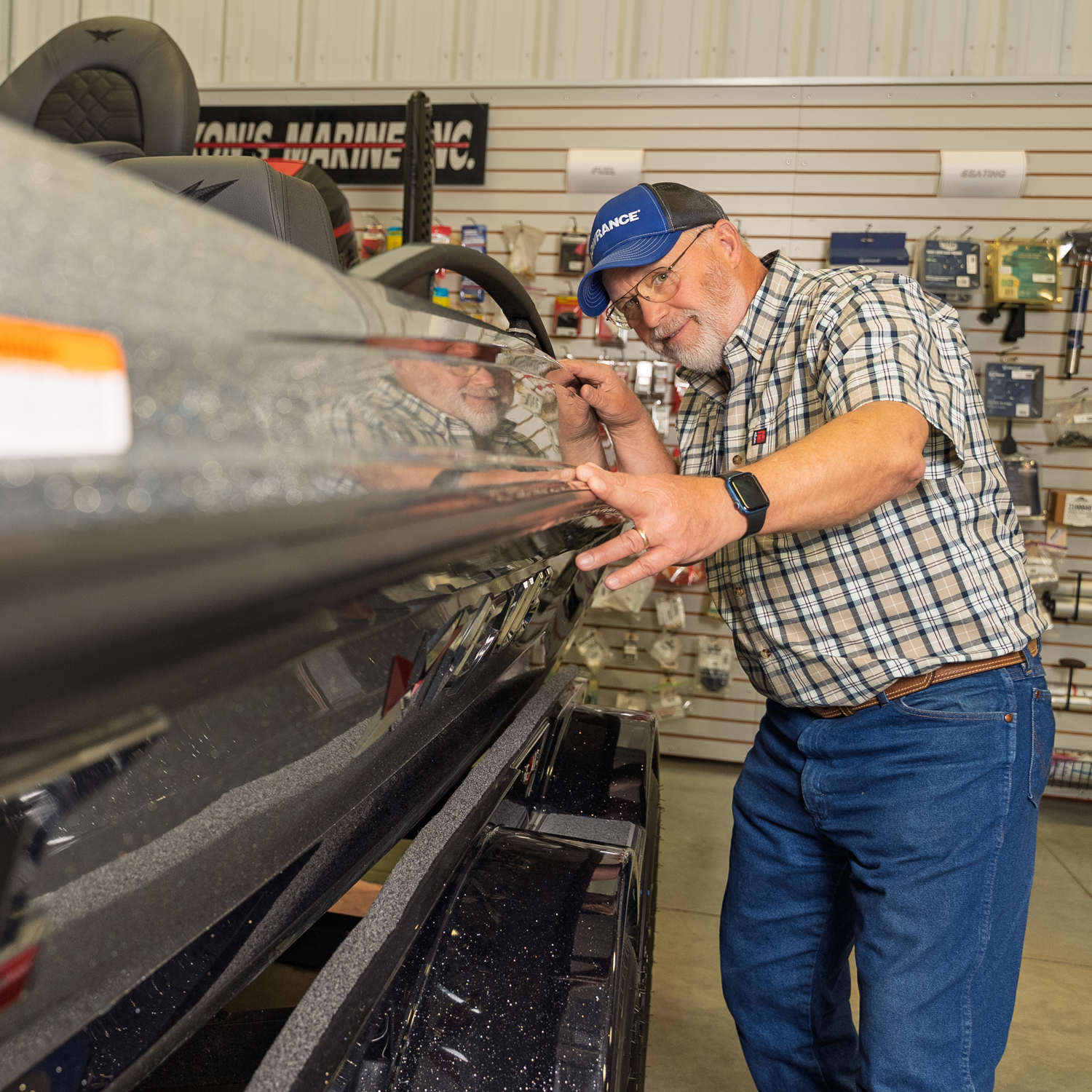 Man inspecting a boat in a store