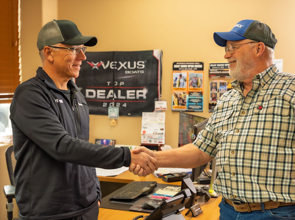 Two men shaking hands in office