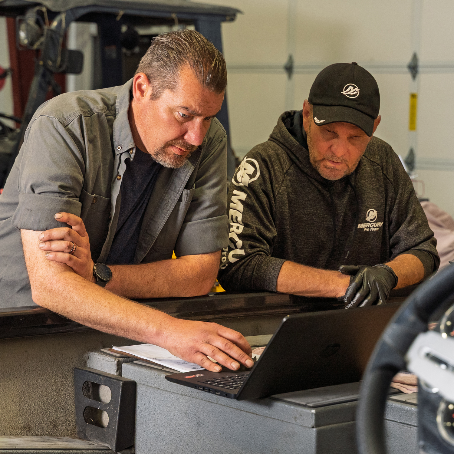 Two men working on a laptop