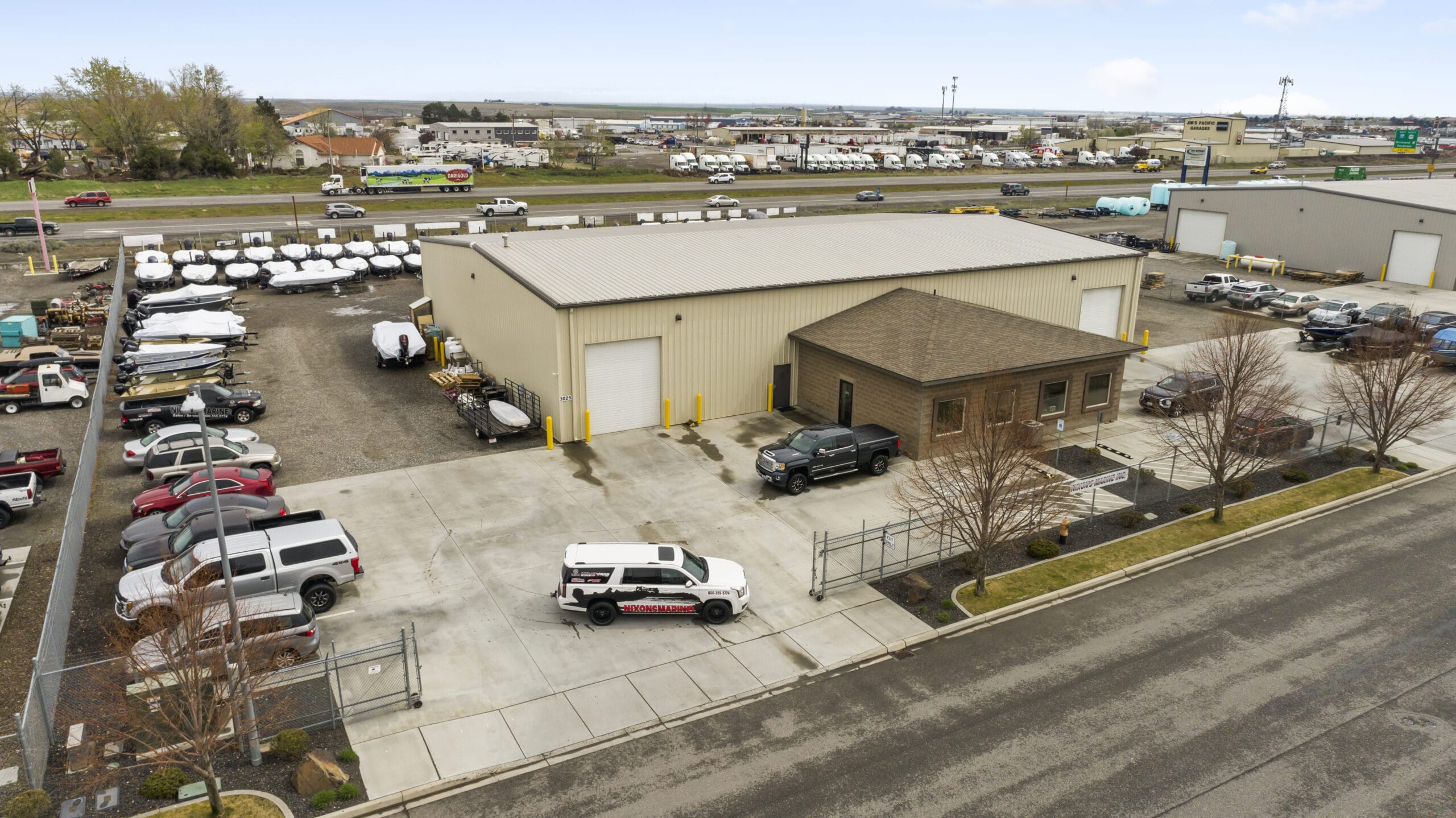 Industrial building with parked vehicles and boats